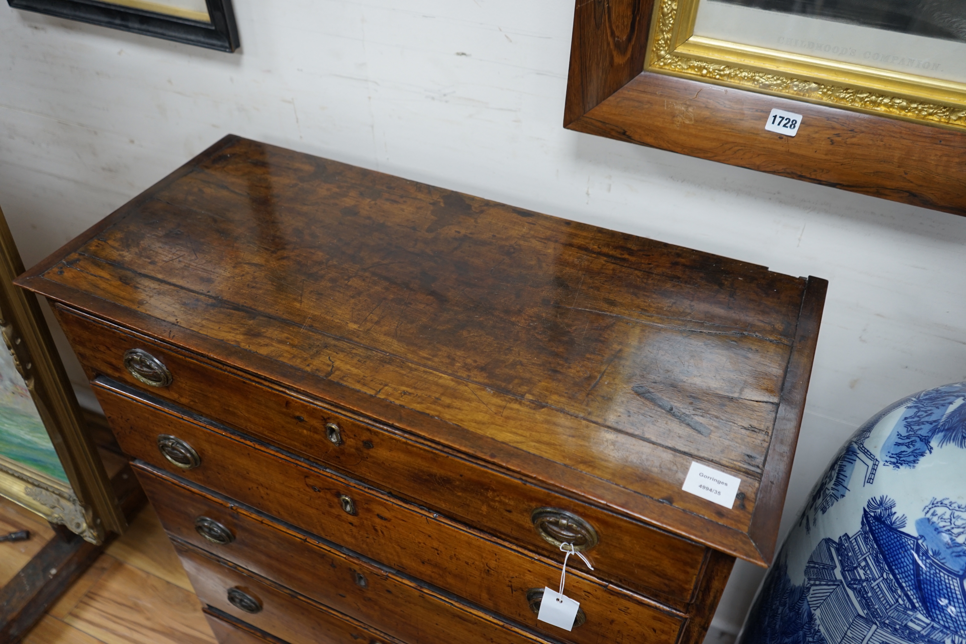 A George III fruitwood chest of five graduating long drawers, width 79cm depth 36cm height 102cm